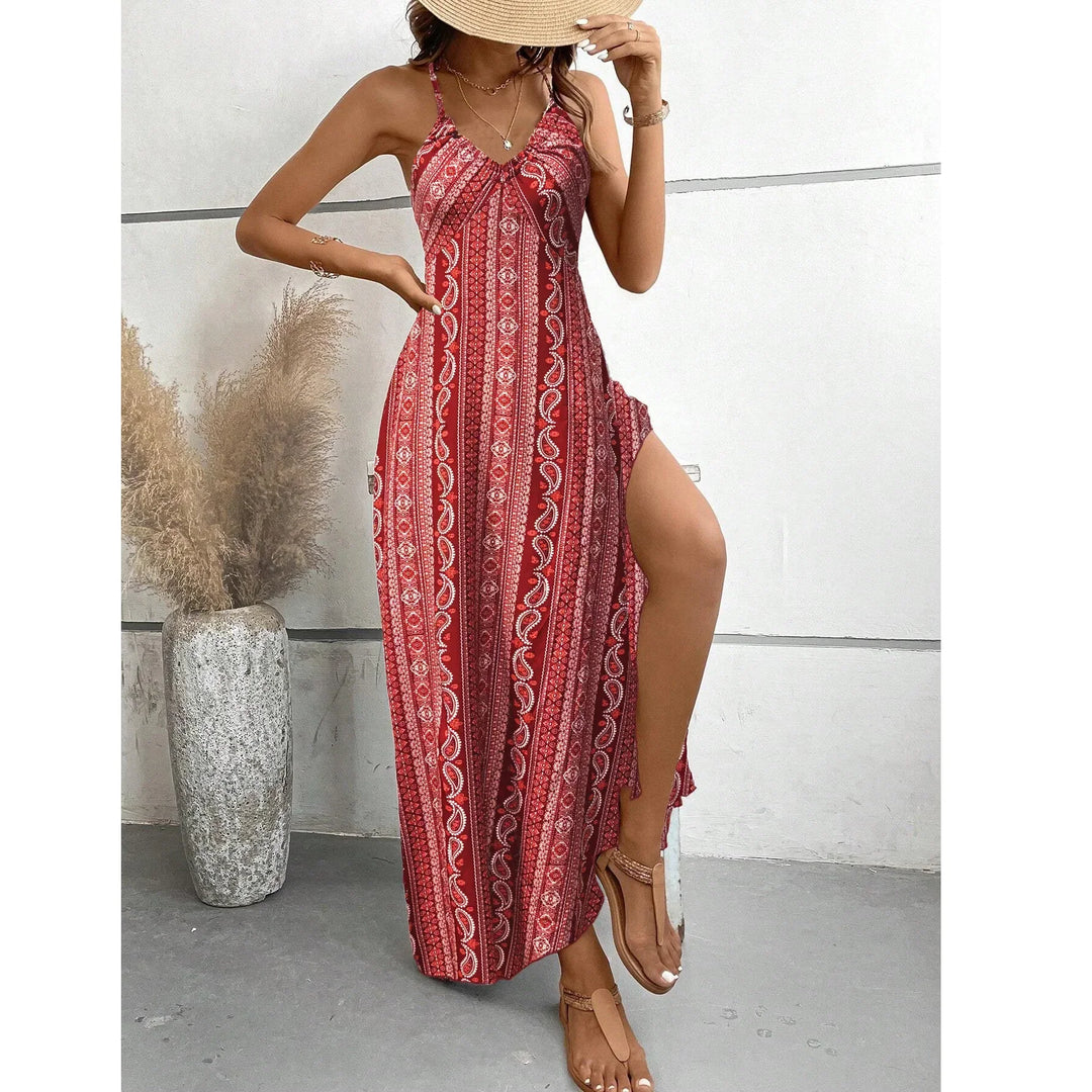 Woman in red boho maxi dress with side slit, straw hat, and sandals, Rovelli fashion