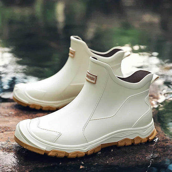 White waterproof ankle boots with tan soles on outdoor rock, Rovelli footwear