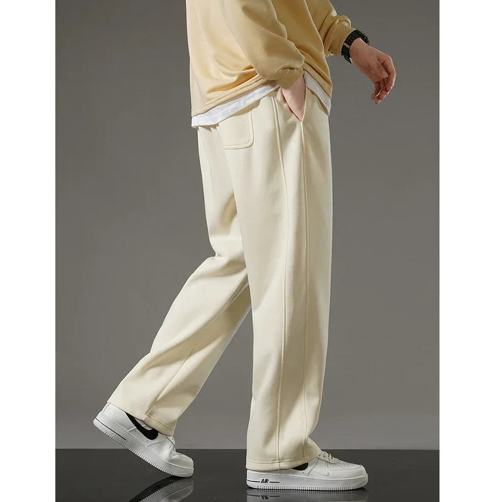 Rovelli cream wide-leg pants styled with white sneakers and a beige sweatshirt