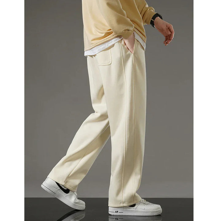 Rovelli cream wide-leg pants styled with white sneakers and a beige sweatshirt