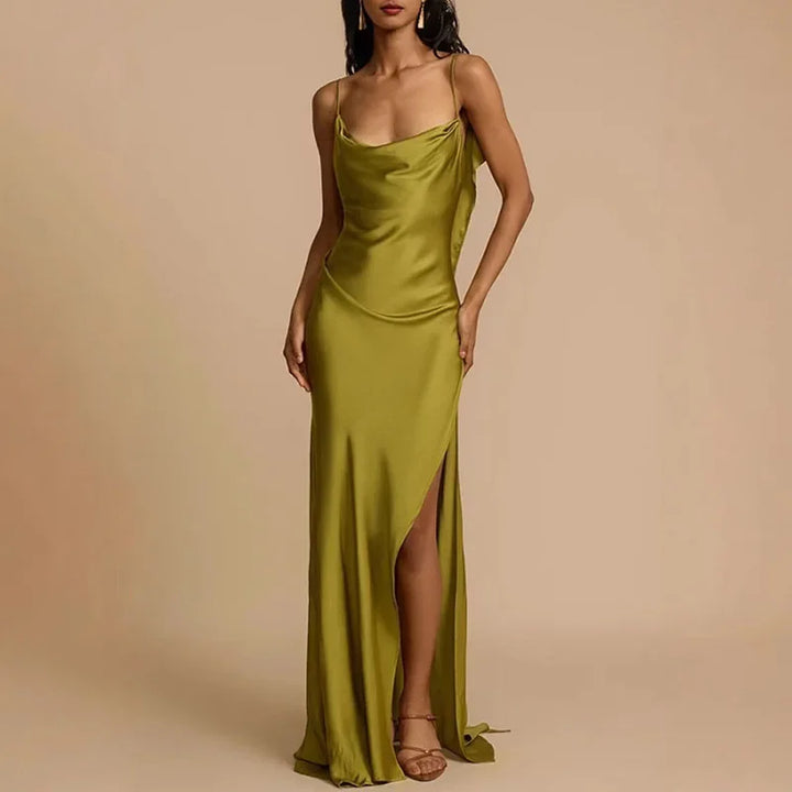 Woman modeling an olive green satin slip dress with a side slit from Rovelli