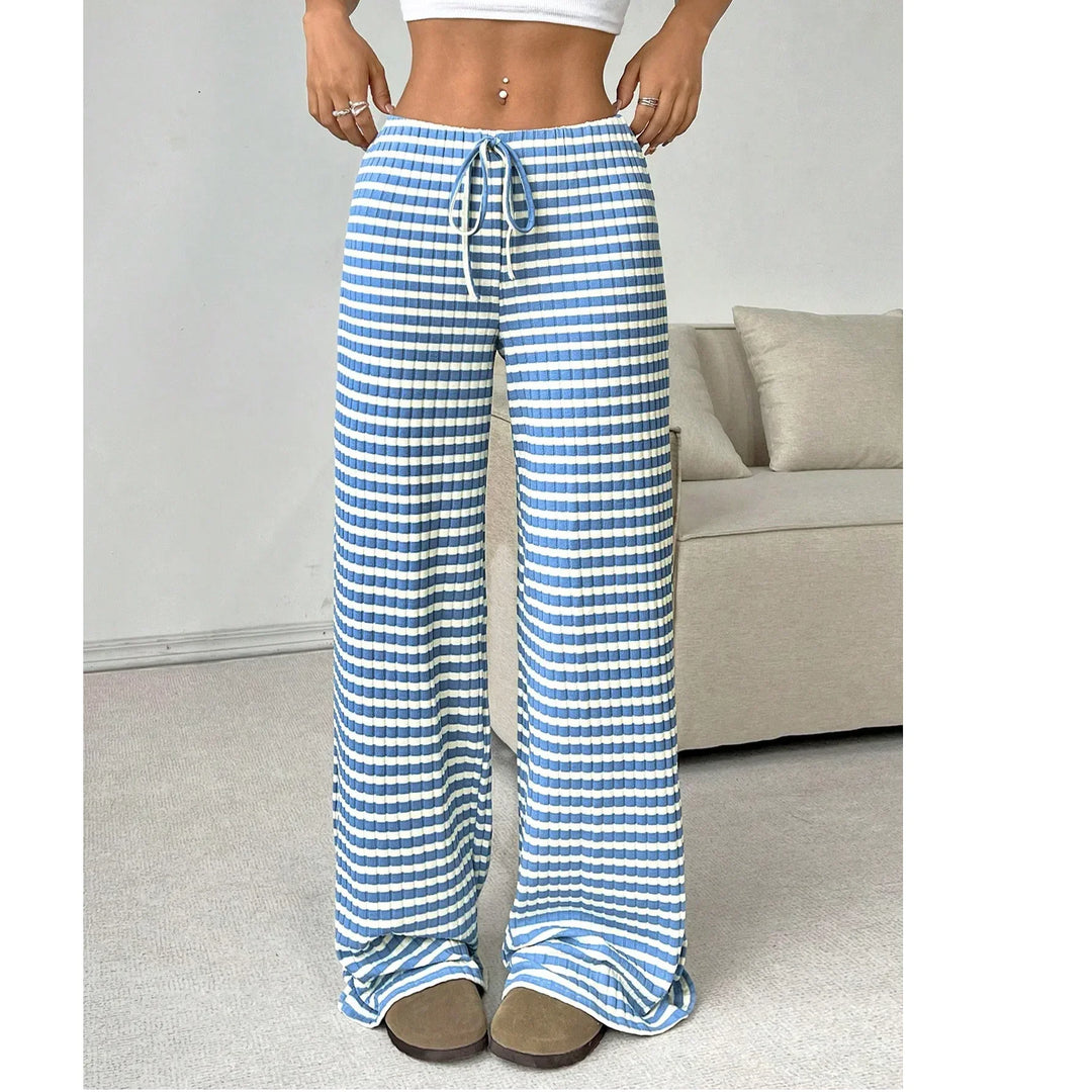 Woman wearing Rovelli blue and white striped wide-leg pants with drawstring waist indoors