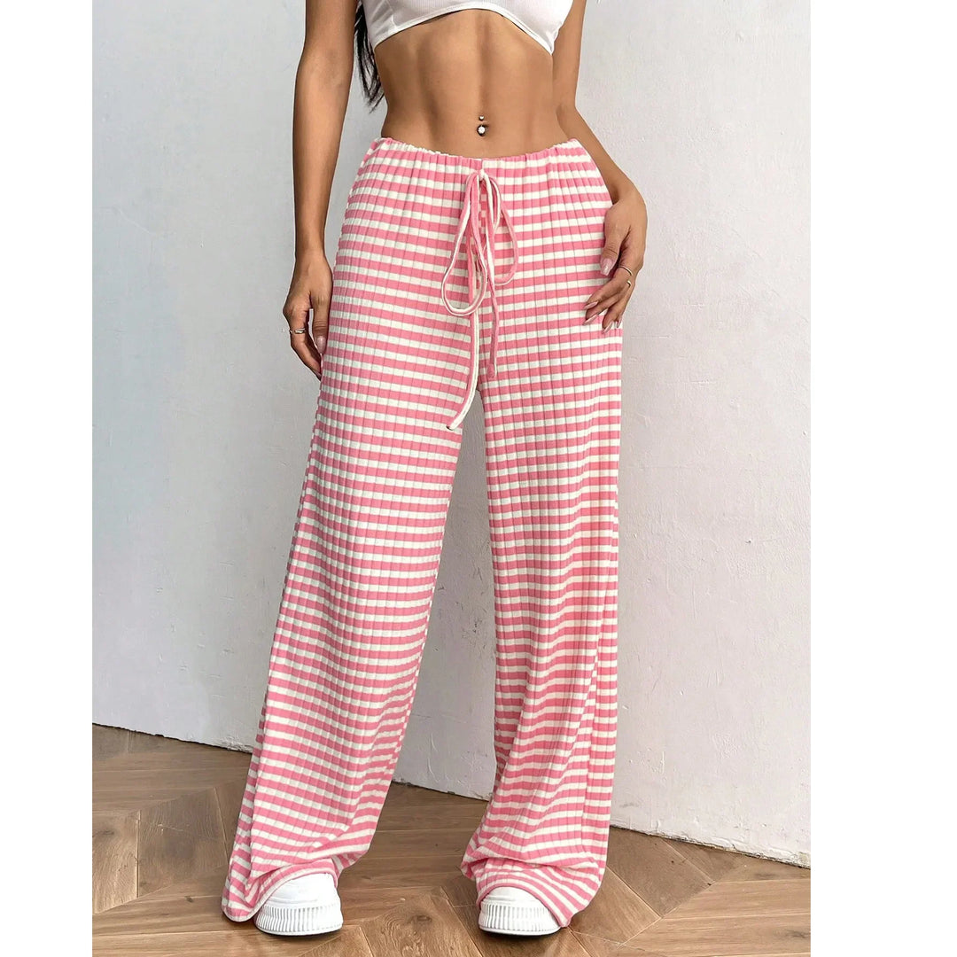 Woman wearing Rovelli pink and white gingham wide-leg pants with drawstring waist