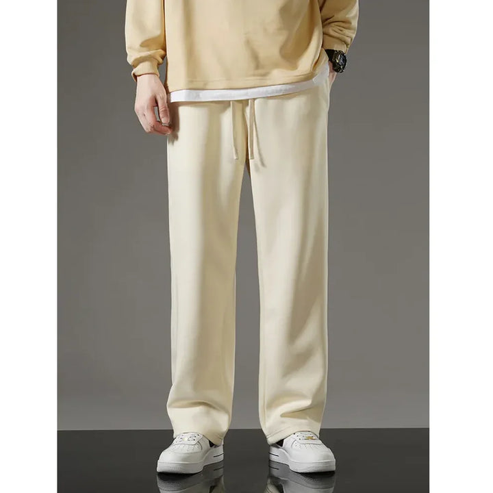 Rovelli cream casual jogger pants with drawstring waist, styled with white sneakers