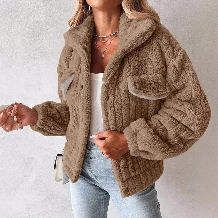 Woman wearing a cozy brown faux fur jacket from Rovelli, paired with jeans and layered necklaces.