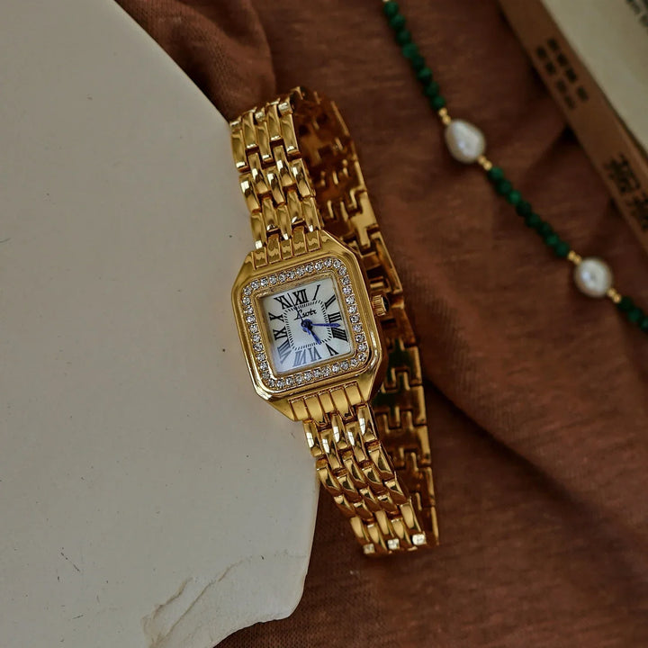 Rovelli gold square luxury wristwatch with Roman numerals and diamond bezel on fabric