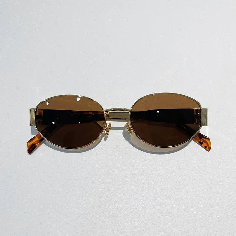 A pair of vintage-inspired sunglasses with gold frames and dark brown tinted lenses, offering Italian style and UV400 protection, displayed against a plain light background.