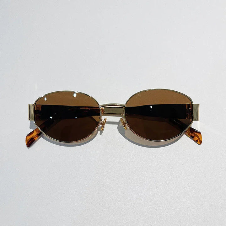 A pair of vintage-inspired sunglasses with gold frames and dark brown tinted lenses, offering Italian style and UV400 protection, displayed against a plain light background.