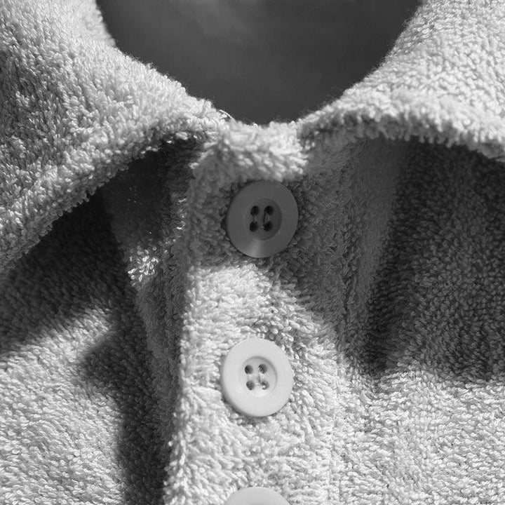 Close-up of textured fabric shirt collar with buttons, Rovelli fashion detail