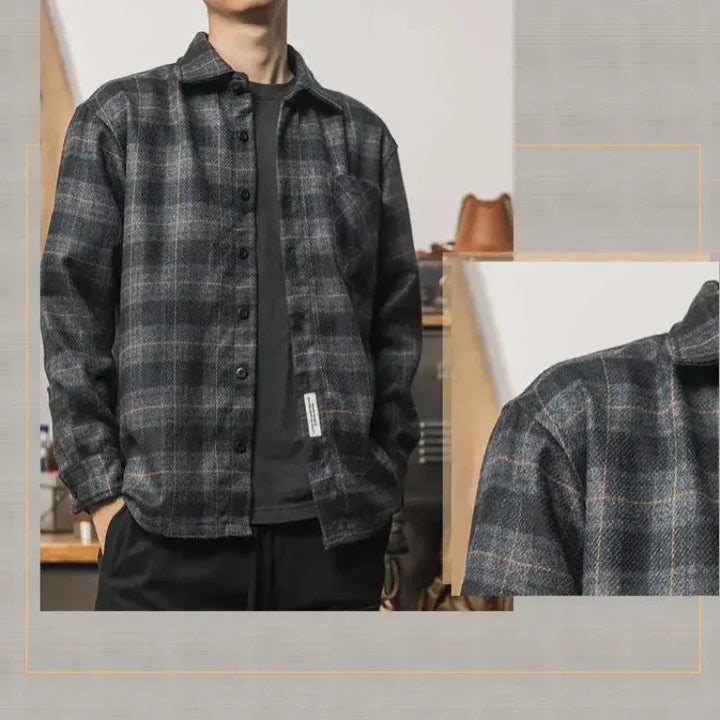 A person wearing a relaxed fit black and gray plaid button-up shirt layered over a dark t-shirt, with hands in pockets, stands indoors. A close-up of the shirts fabric appears on the right side.
