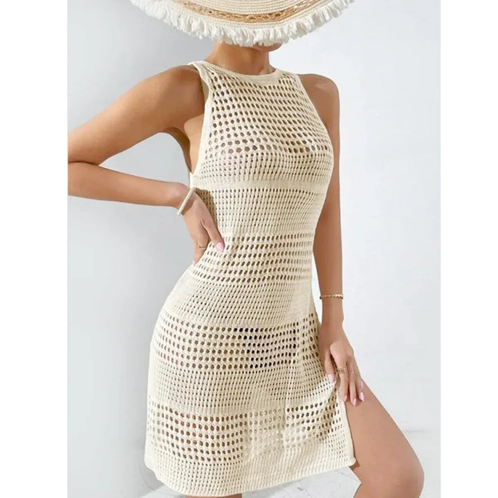 Woman wearing cream crochet beach dress and sun hat, Rovelli summer fashion
