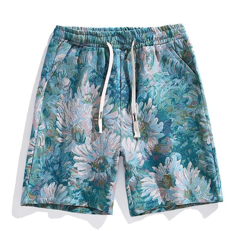 Colorful designer shorts with an elastic waistband and white drawstrings, featuring a vibrant floral pattern in teal, blue, green, and white with large daisy-like flowers. Elevate your style with these premium quality shorts.