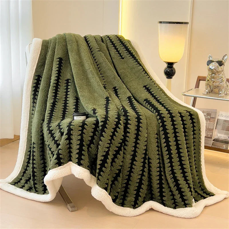 Plush green and black Rovelli throw blanket with white trim draped over chair in modern room