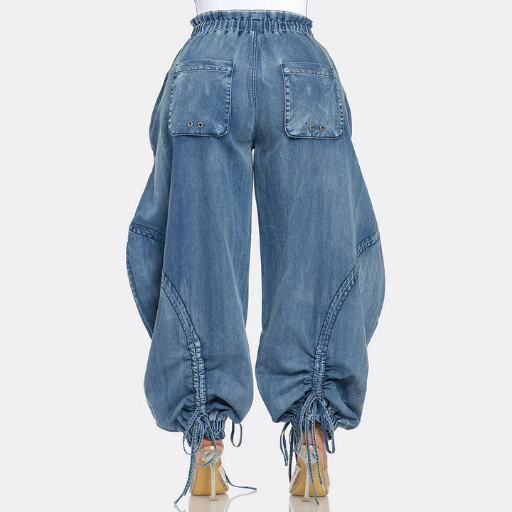 Back view of wide-leg denim pants with drawstring hem and large back pockets, Rovelli fashion