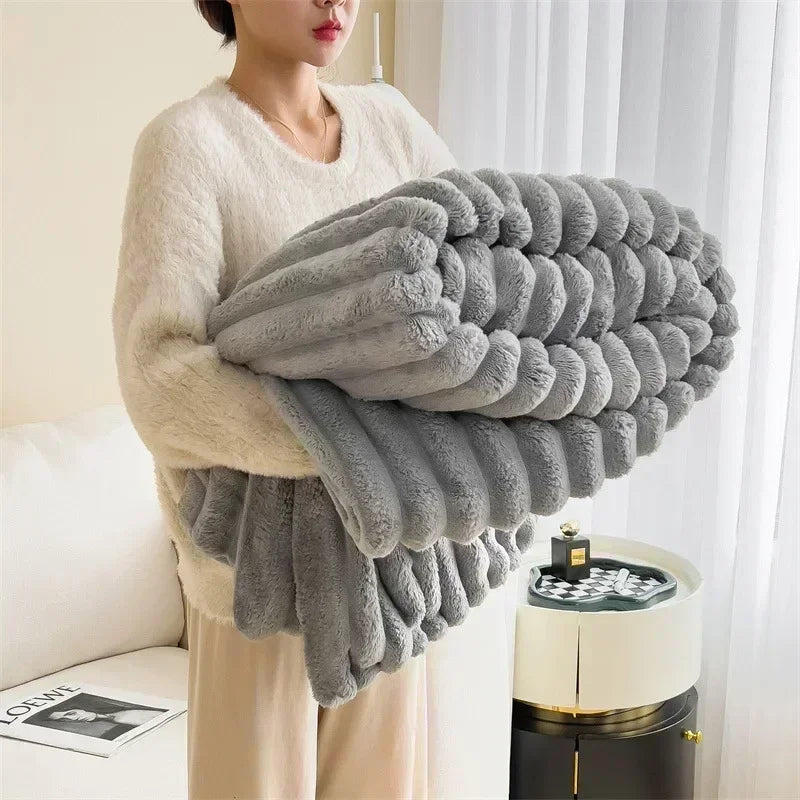 Woman holding folded gray plush blanket in cozy modern living room, Rovelli home decor