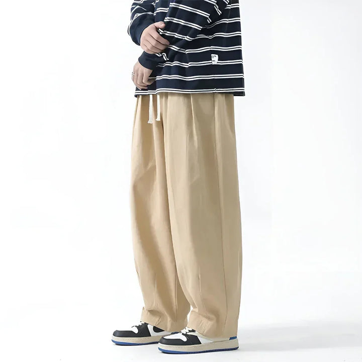Rovelli beige wide-leg pants with drawstring, styled with striped shirt and sneakers