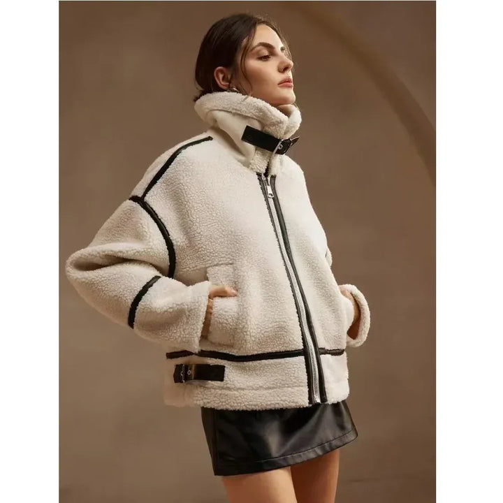 Woman wearing a white shearling aviator jacket with black trim from Rovelli