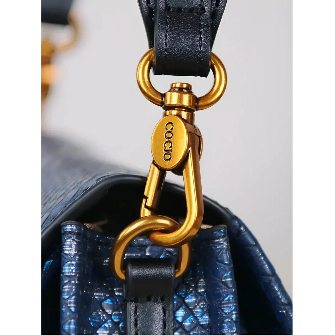 Rovelli blue textured handbag with gold clasp and black leather strap detail
