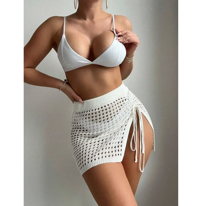 Woman modeling white bikini top and mesh knit mini skirt, Rovelli fashion style