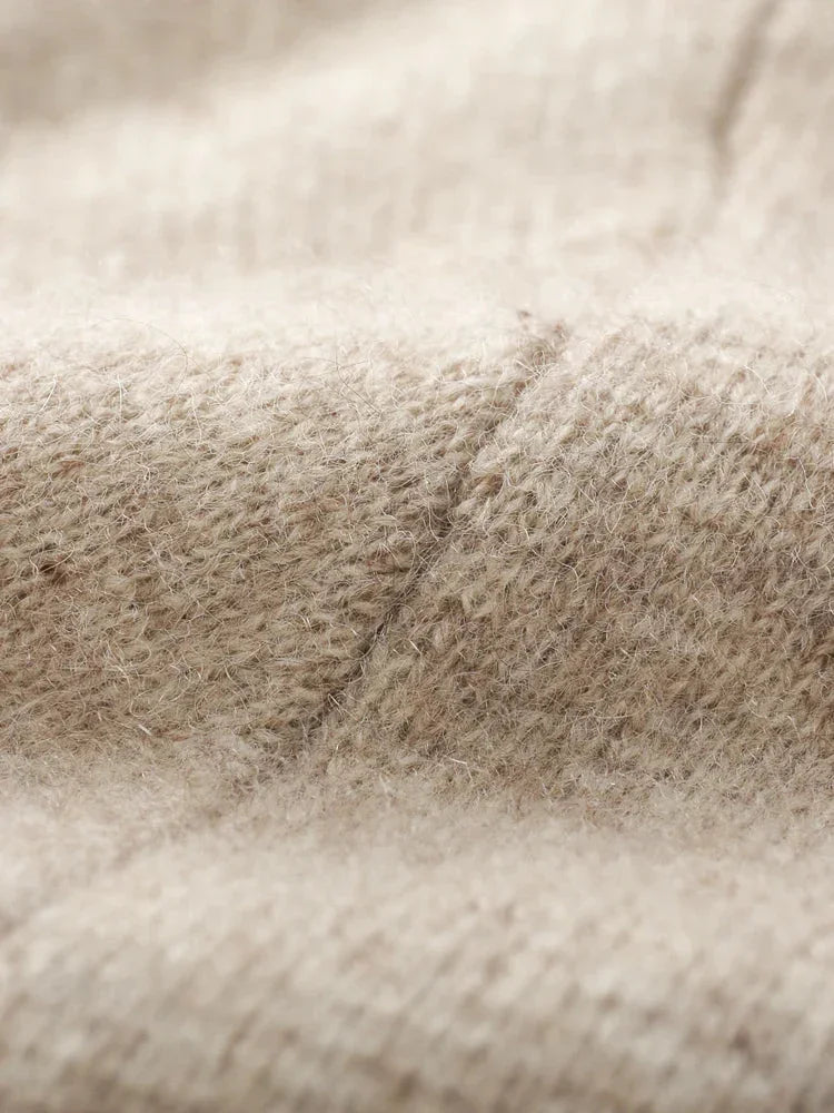Close-up of a beige knit cardigan, highlighting its soft, fuzzy texture and detailed stitching—perfect for an autumn winter cardigan.