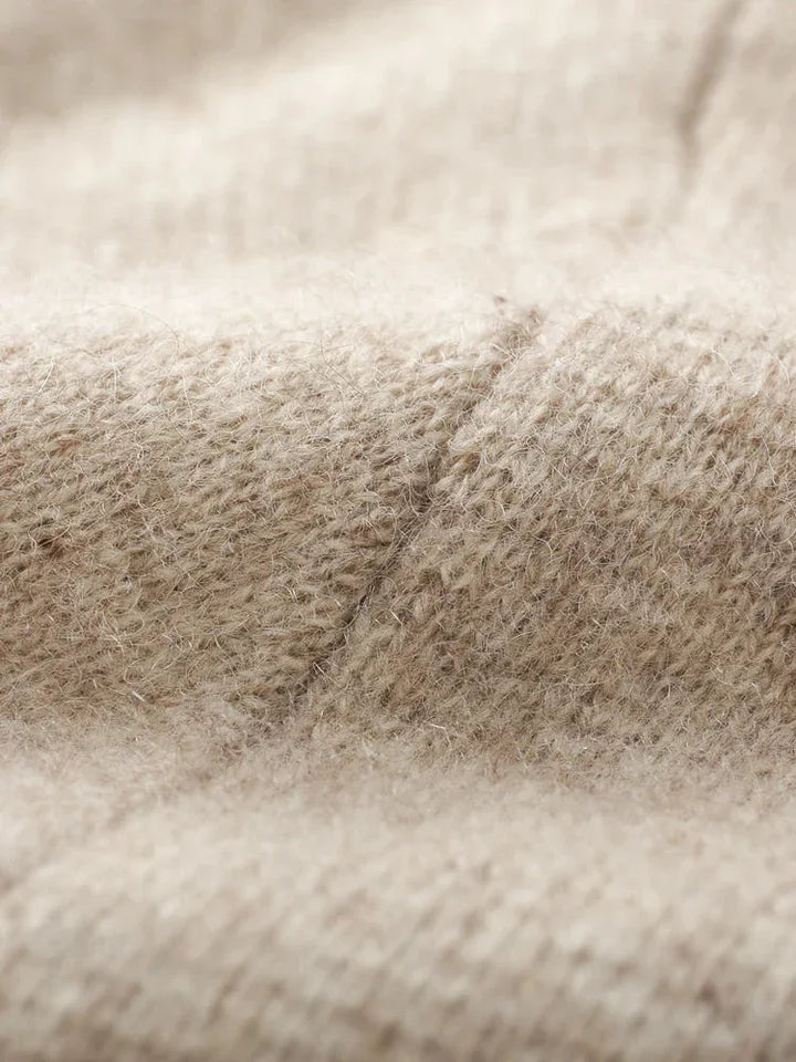 Close-up of a beige knit cardigan, highlighting its soft, fuzzy texture and detailed stitching—perfect for an autumn winter cardigan.