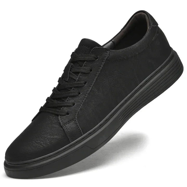 Rovelli classic black sneaker with textured sole and lace-up front on white background