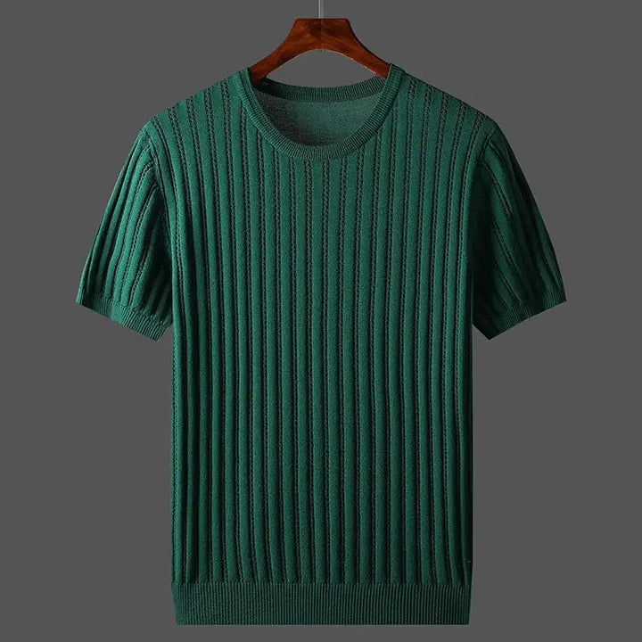 A green, short-sleeved, ribbed knit cashmere-cotton tee with a classic fit hangs on a wooden hanger against a plain gray background.