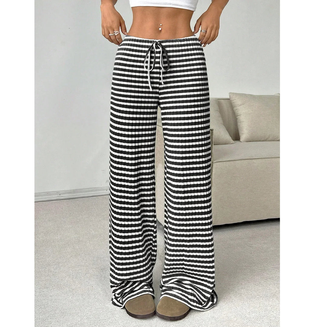 Woman wearing black and white striped wide-leg lounge pants from Rovelli