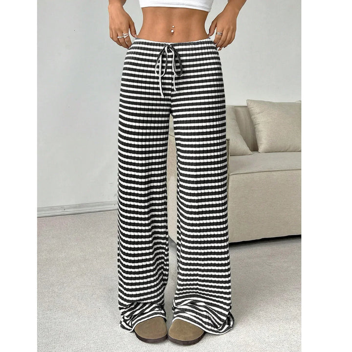 Woman wearing black and white striped wide-leg lounge pants from Rovelli