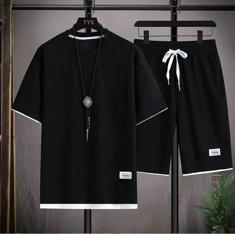 Rovelli black short sleeve shirt and shorts set with white trim and necklace on hanger