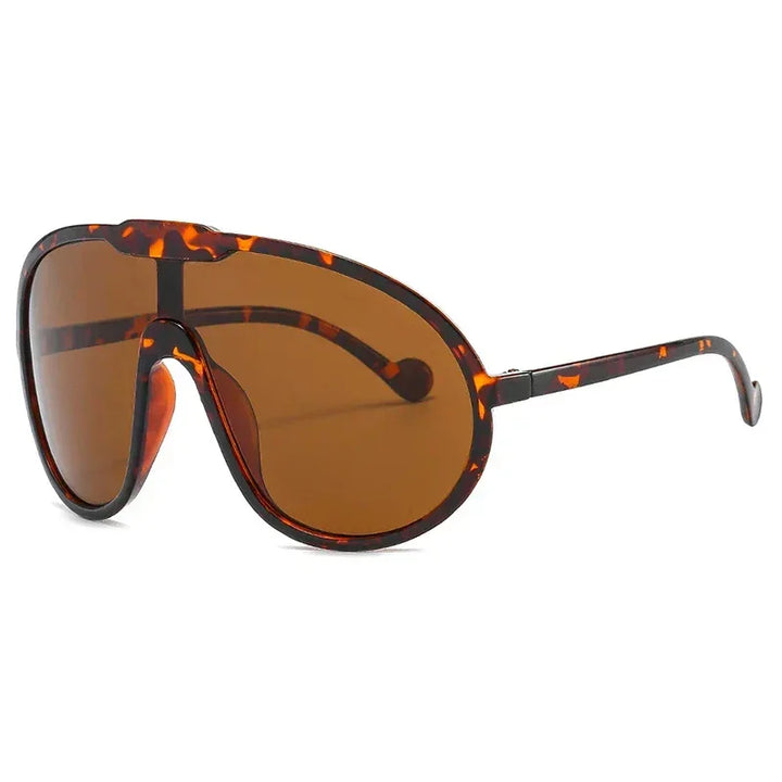 Brown tortoiseshell oversized sunglasses with wraparound lenses and thick frames, offering UV400 protection, shown at an angle on a white background. Perfect for outdoor activities.