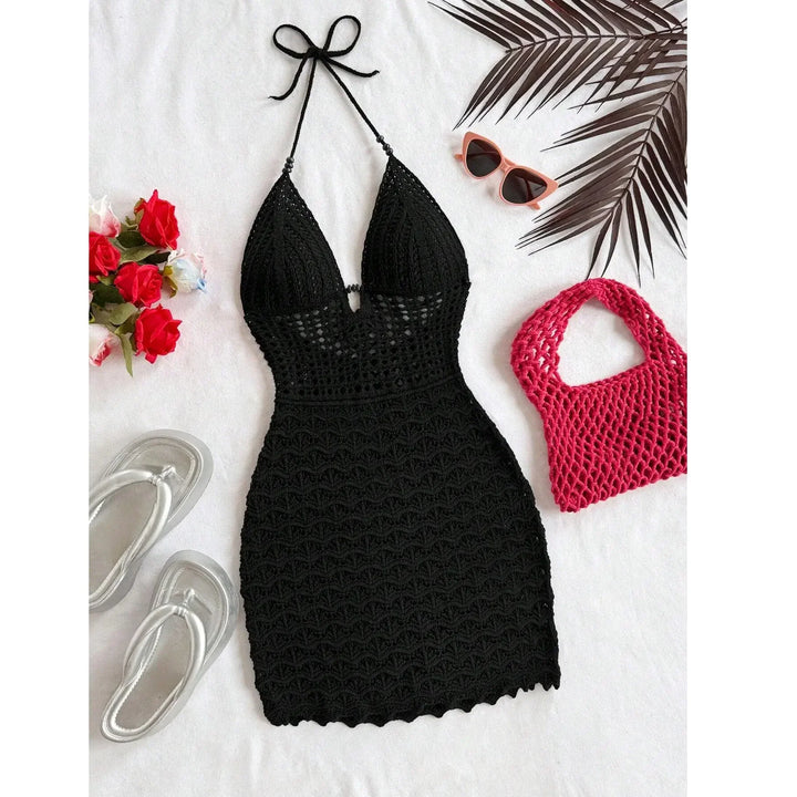 Rovelli black crochet halter dress with silver sandals, red bag, sunglasses, flowers, palm leaves