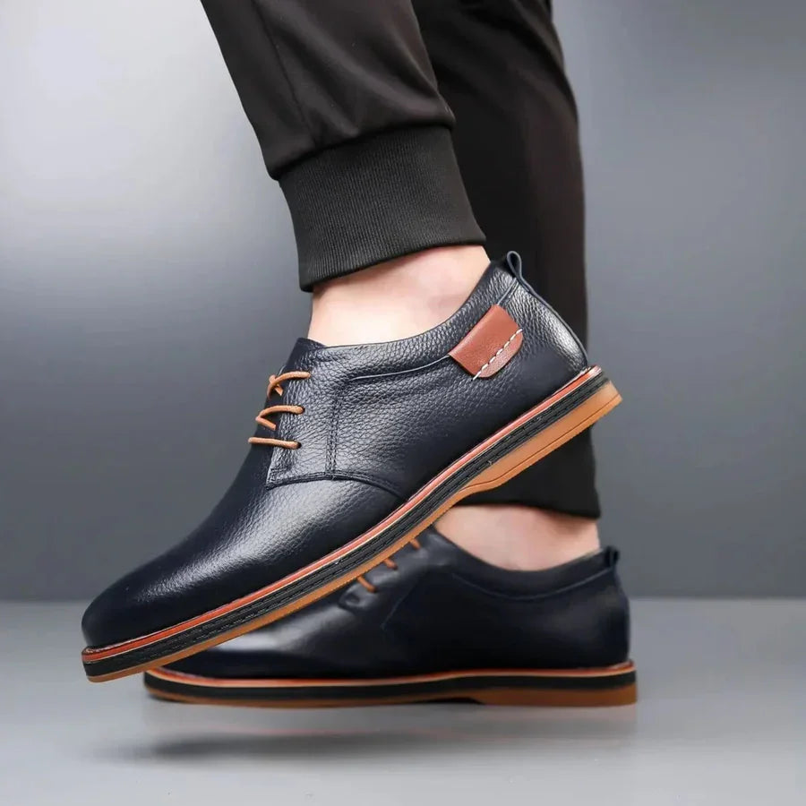Rovelli navy leather lace-up dress shoes with brown accents and rubber sole, worn on foot