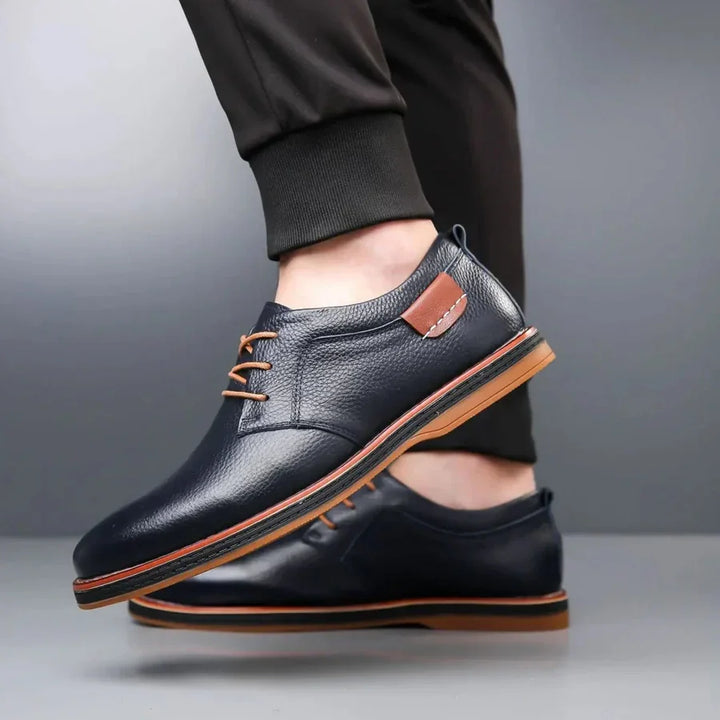 Rovelli navy leather lace-up dress shoes with brown accents and rubber sole, worn on foot