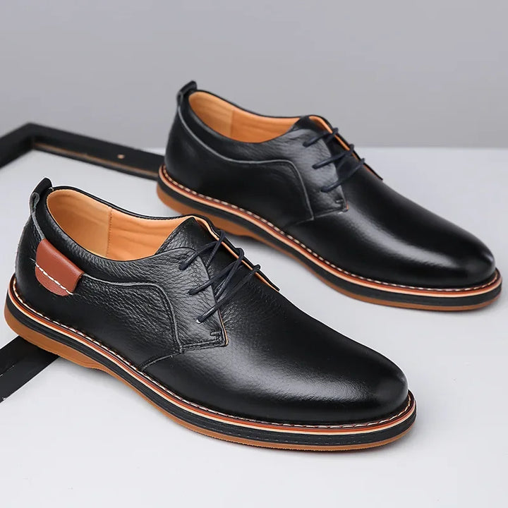 Rovelli black leather dress shoes with tan sole and lace-up design on white background