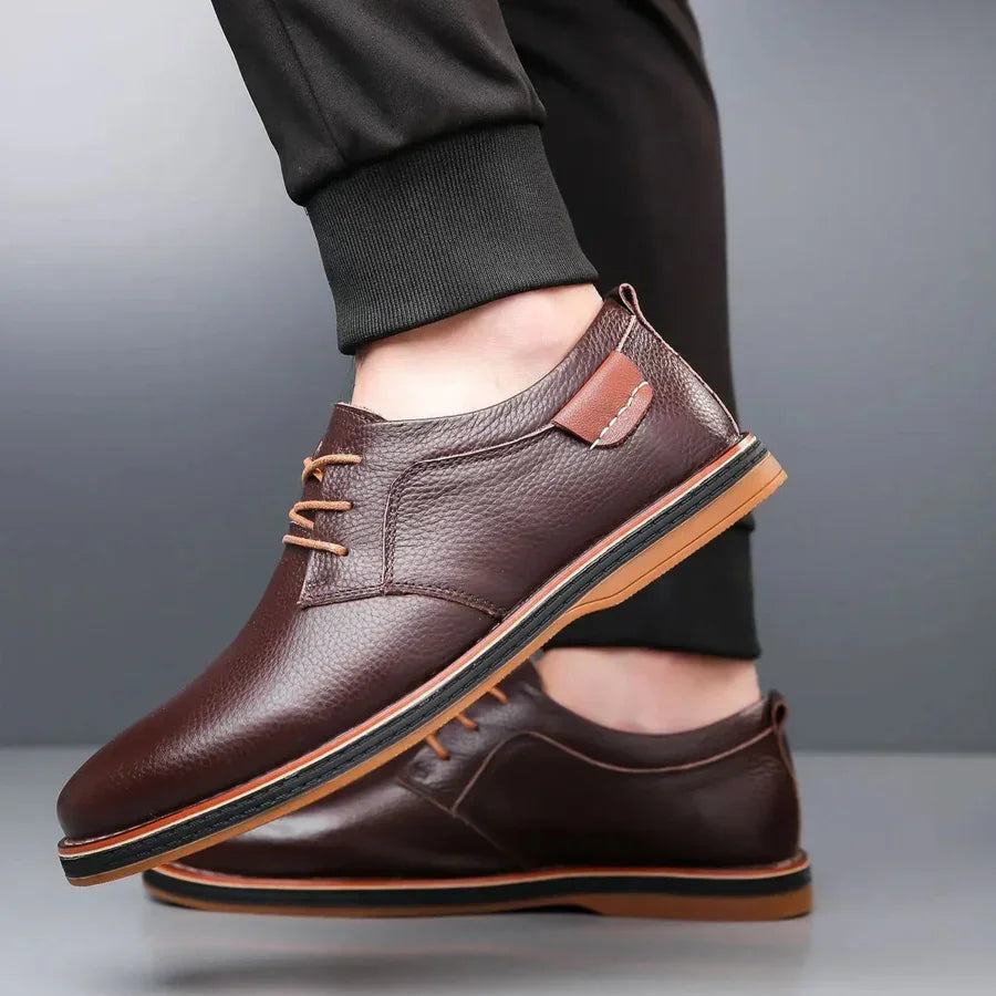 Rovelli brown leather lace-up dress shoes with tan sole on grey background