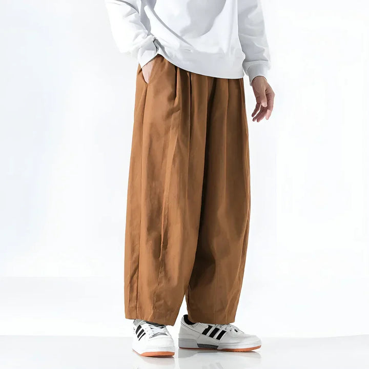 Wide-leg brown pants Rovelli, styled with white sweatshirt and sneakers, on model