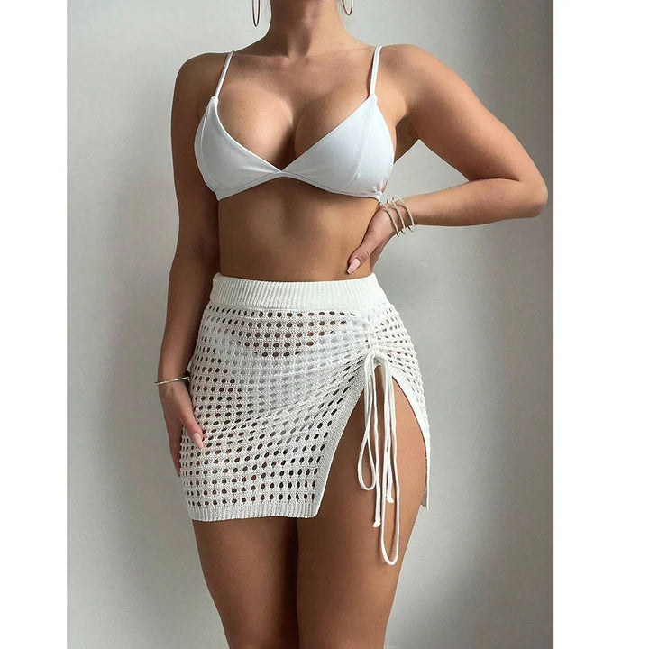 Woman wearing white crochet mini skirt and bikini top, Rovelli fashion style