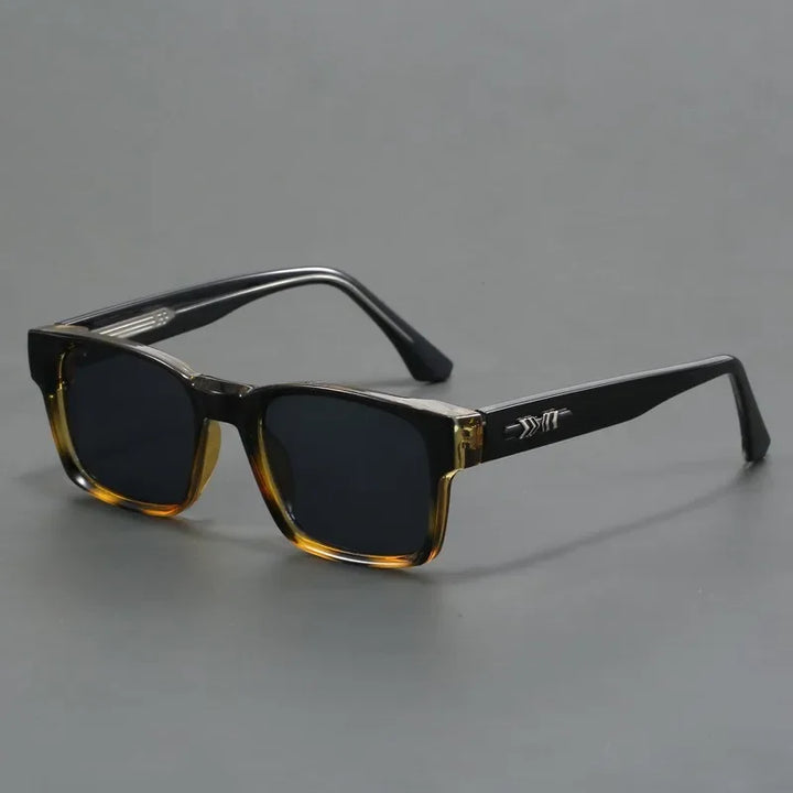 A pair of rectangular sunglasses with durable frames, black arms, and dark lenses. The frames feature a gradient from transparent brown at the bottom to black at the top, plus a silver arrow detail on the arms.