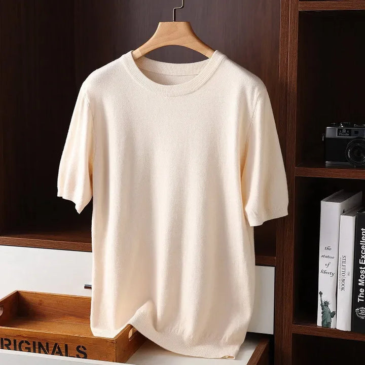Rovelli cream knit short sleeve sweater neatly hung in modern wooden shelving unit