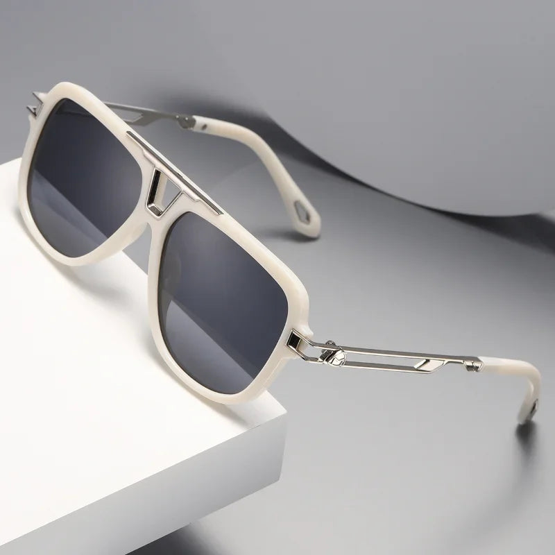 Off-white, luxury designer square sunglasses with silver metal arms and dark lenses rest on a white and gray surface in a minimalist setting.