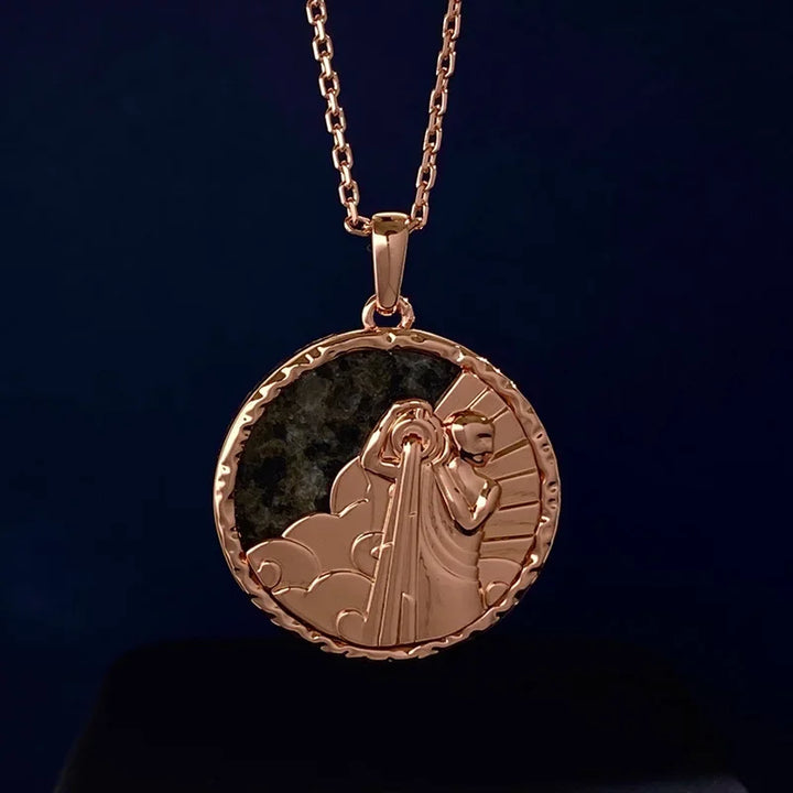 A gold zodiac necklace featuring a round medallion with an engraved figure holding a torch, surrounded by clouds and rays, set against a dark background—a timeless piece of astrology jewelry.