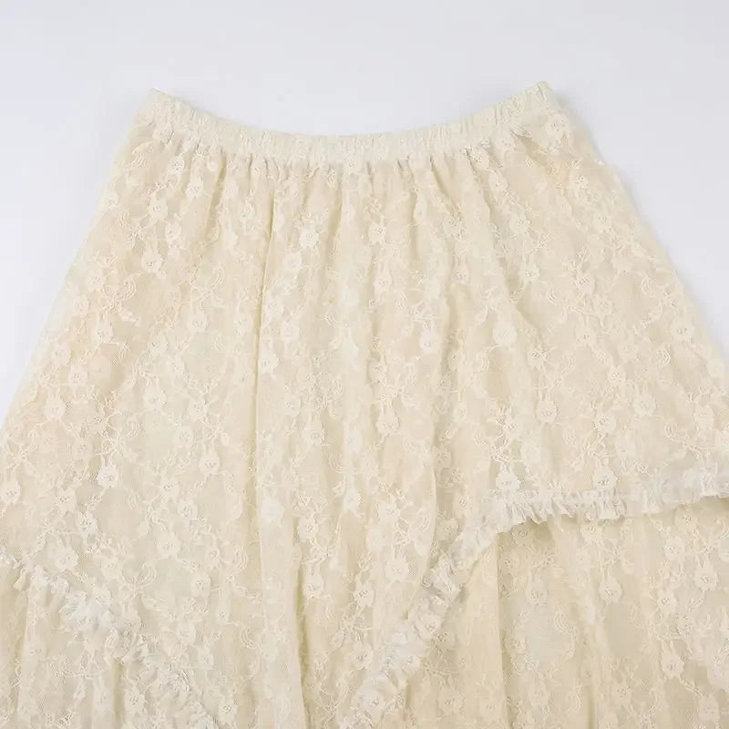 A cream-colored lace skirt with a high waist and elastic waistband, featuring a delicate floral pattern and a soft, flowing texture. The silky lace fabric appears lightweight and slightly sheer.