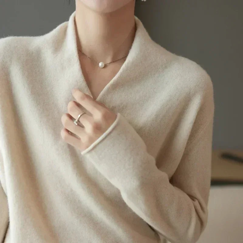 Rovelli soft beige sweater with v-neck, pearl necklace, and silver ring