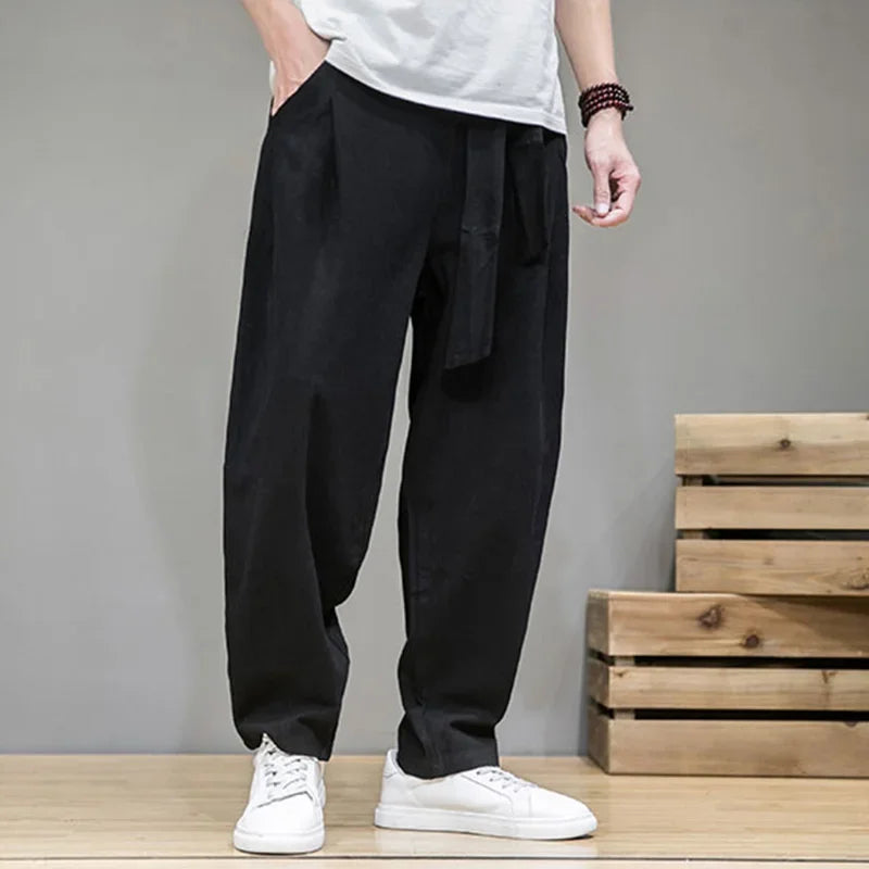 Rovelli men's black relaxed fit trousers with tie waist, styled with white sneakers