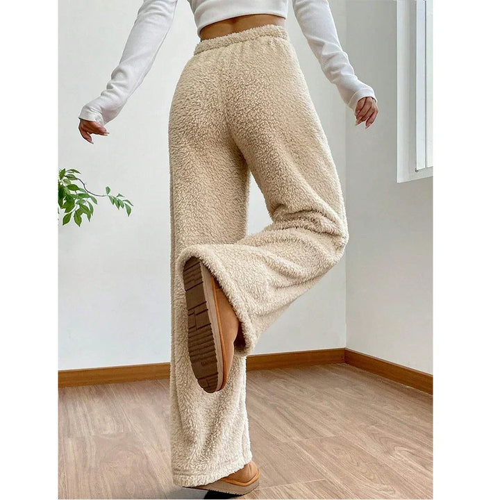 Rovelli beige fleece lounge pants with elastic waist, modeled indoors on wood floor