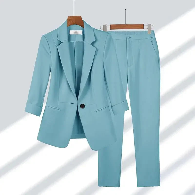 Light blue women's suit set with blazer and trousers on hangers, Rovelli fashion