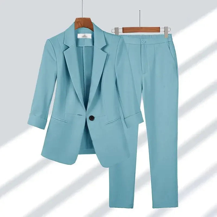 Light blue women's suit set with blazer and trousers on hangers, Rovelli fashion
