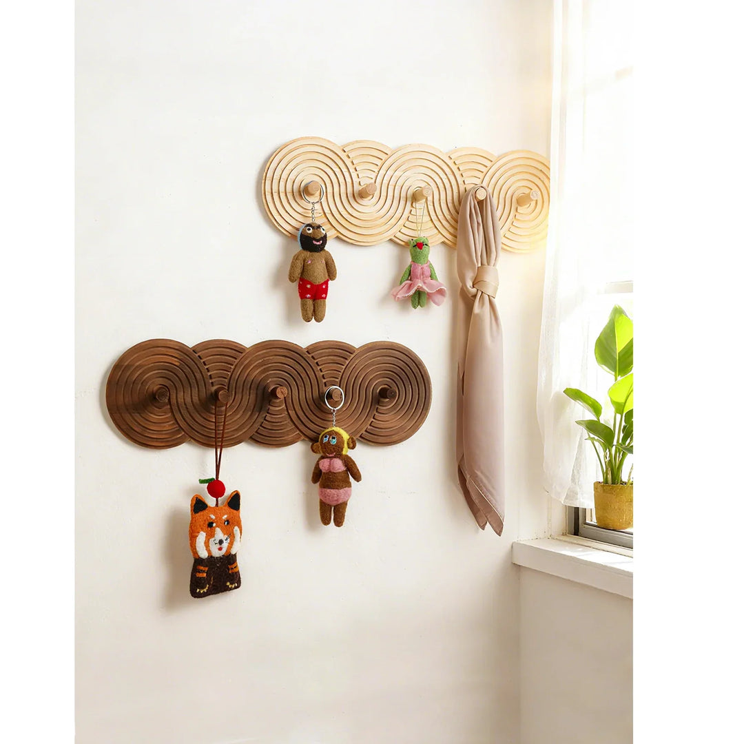 Rovelli cloud-shaped wooden wall hooks with plush toys and scarf in sunlit room
