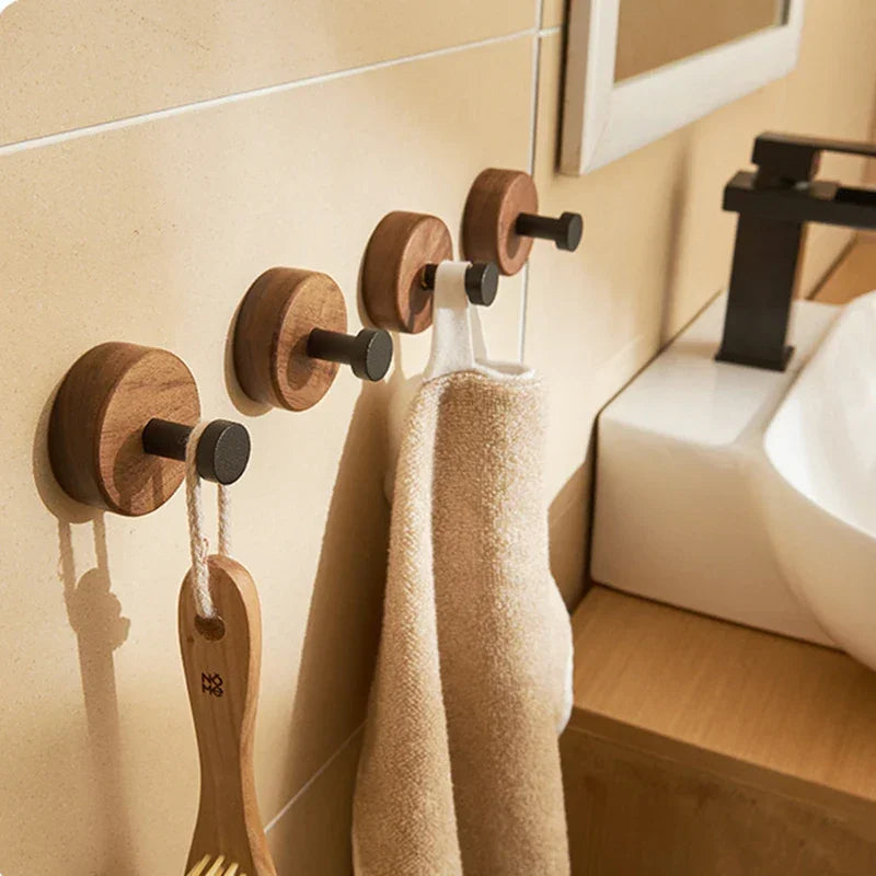 Wooden wall hooks with towels and brush in a modern Rovelli bathroom setting